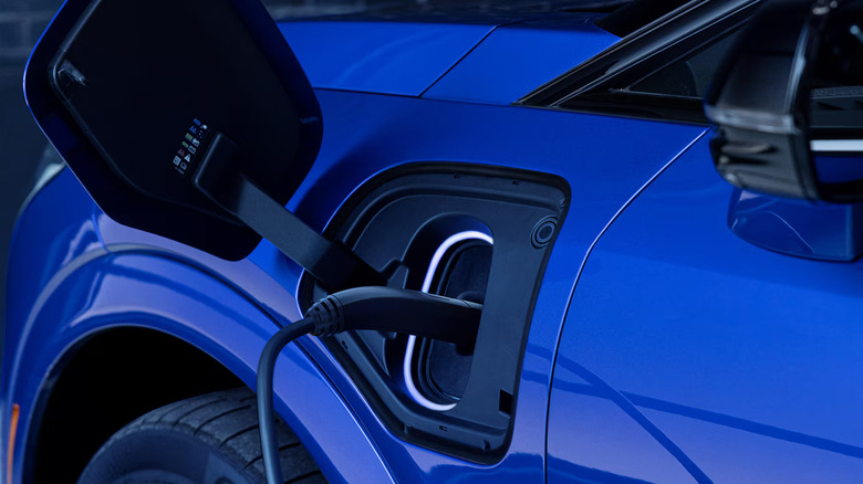 Close-up of a blue Cadillac SUV EV charging port