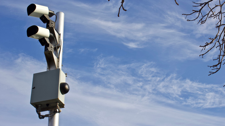 Automated license plate readers on a pole against blue sky