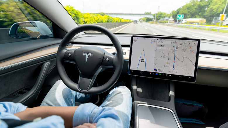 A person sitting in a self-driving car.