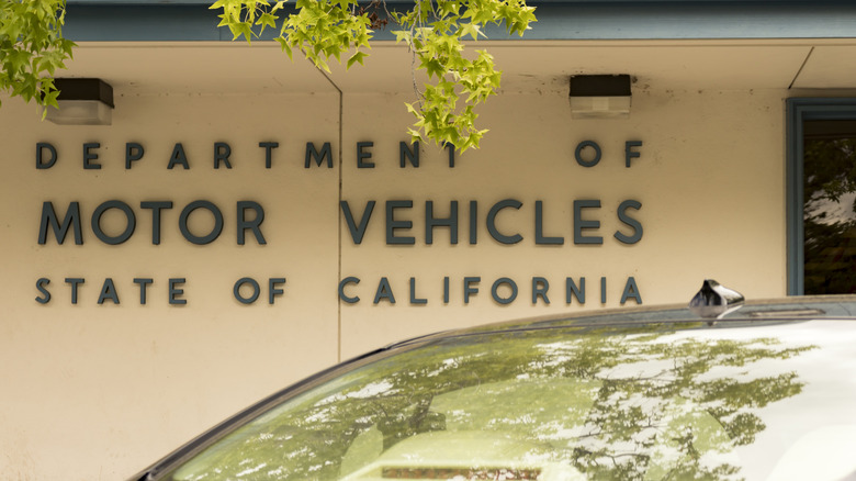 A car is parked outside a California Department of Motor Vehicles office.