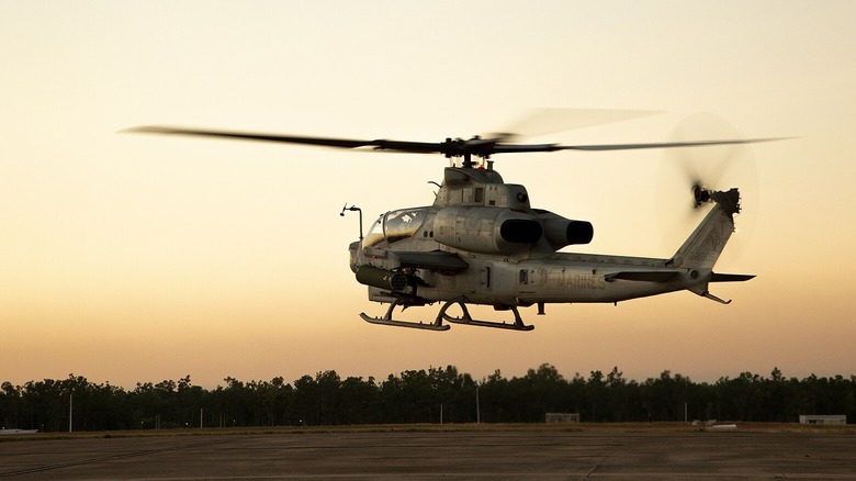 Marine Corps AH-1 Viper hover in sunset