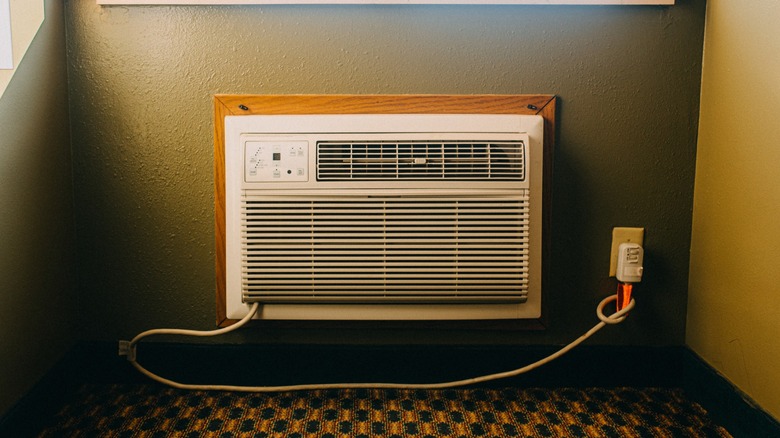 Window unit AC in a home framed into the wall and plugged into the wall