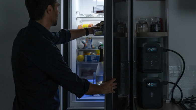Man getting food from fridge powered by EcoFlow portable power station
