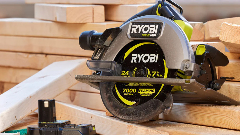 A Ryobi circular saw on a pile of lumber.