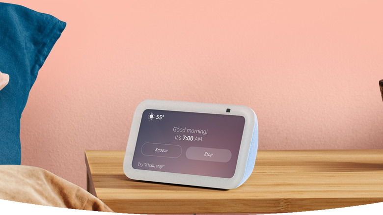 Amazon Echo Show 5 on bedside table showing an alarm
