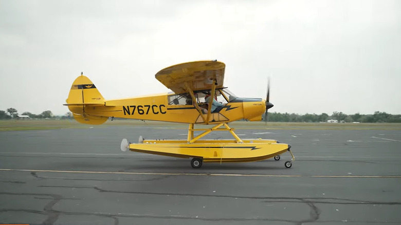 A floatplane with wheels preparing to to take off.
