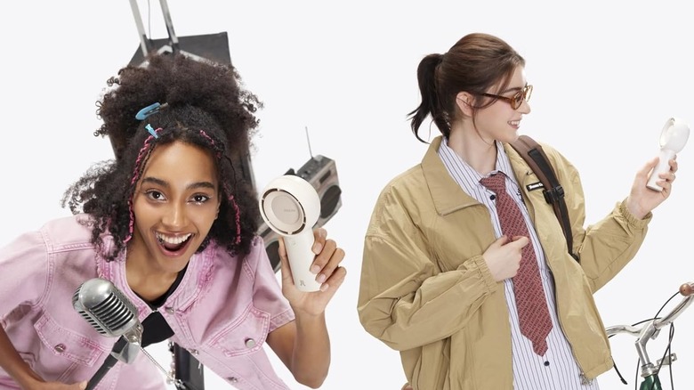 Girls using portable fan