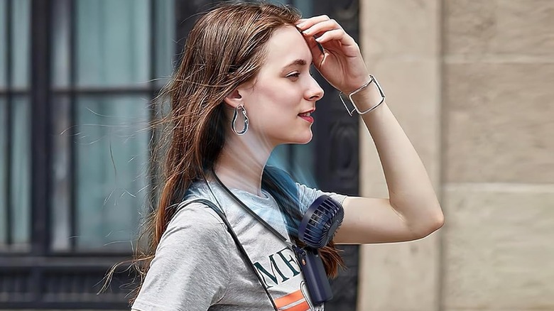 woman with a portable neck fan