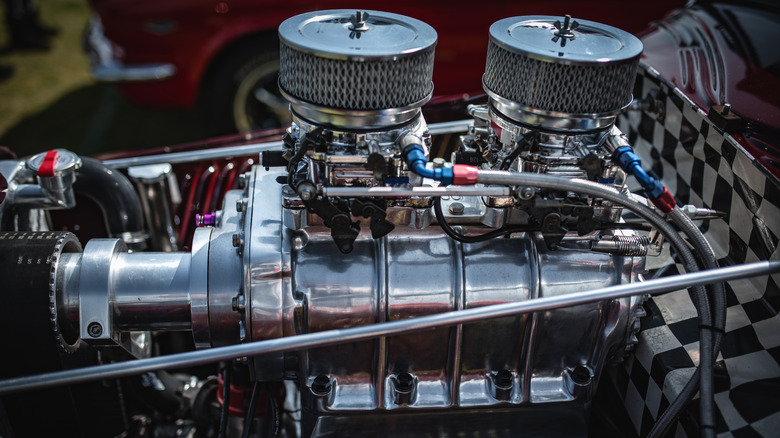 A close up shot of a classic car's supercharged engine.
