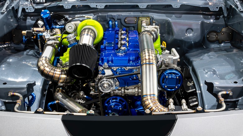 Open engine bay of a truck with a custom supercharged diesel engine.