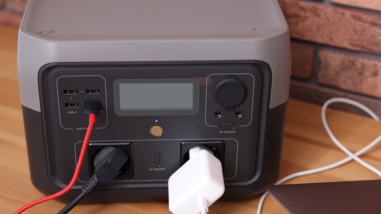 Black and gray portable power station in use