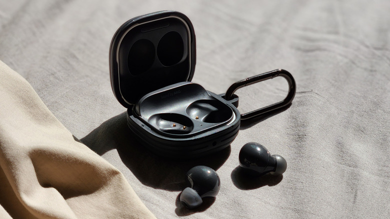 An open Samsung Galaxy Buds case open with both buds in front.