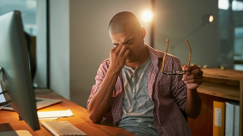 Frustrated guy working on a computer