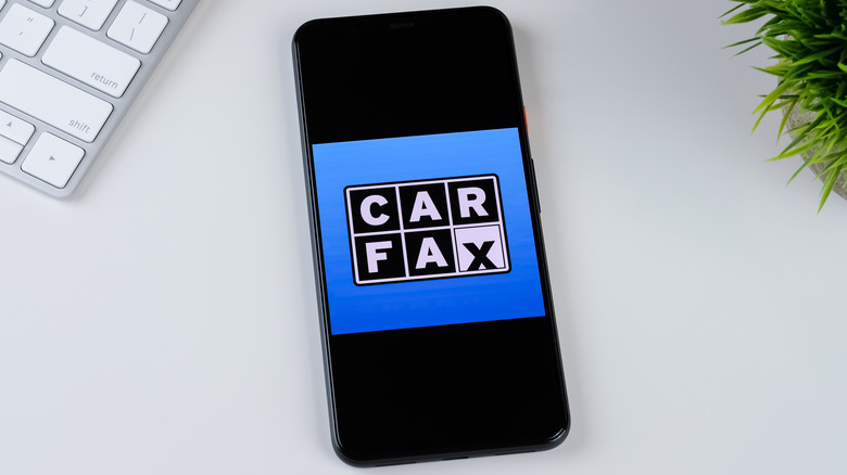 Cell phone with Carfax logo on table