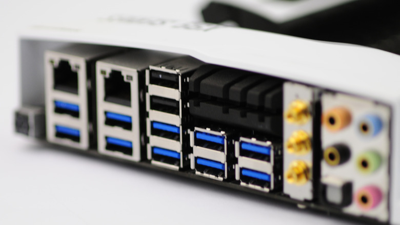 Close-up of rear motherboard connections, showing USB, ethernet, and audio ports