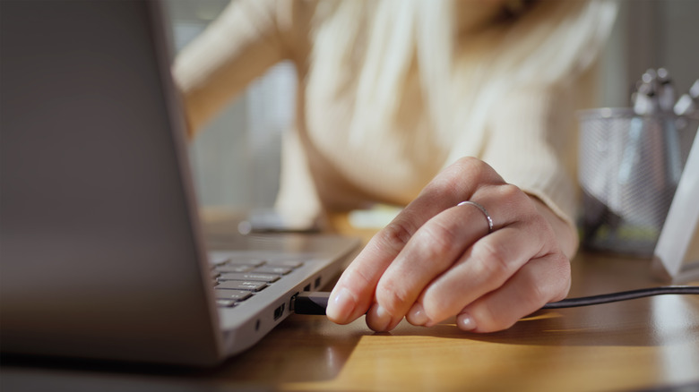 a person charging a laptop