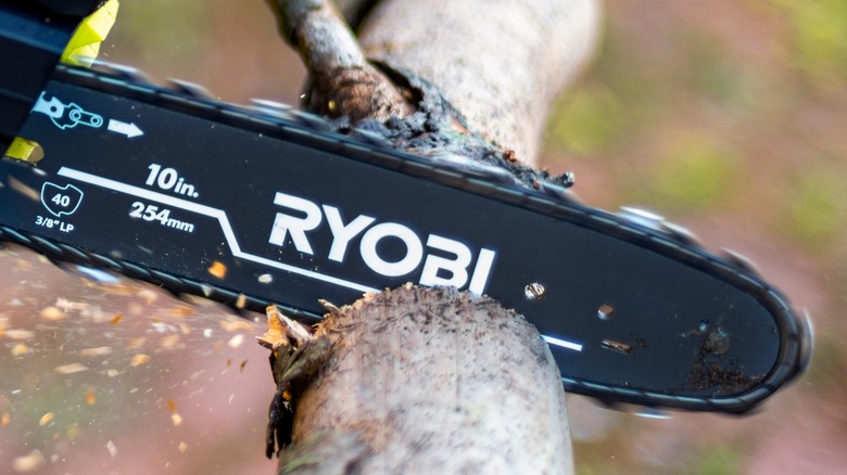 person using ryobi saw