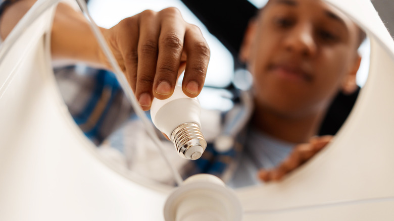 Person screwing in light bulb