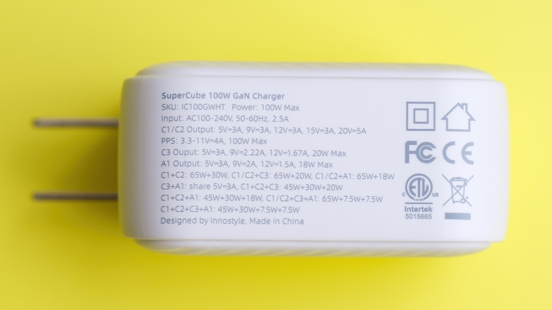 100W GaN phone charger showing ratings