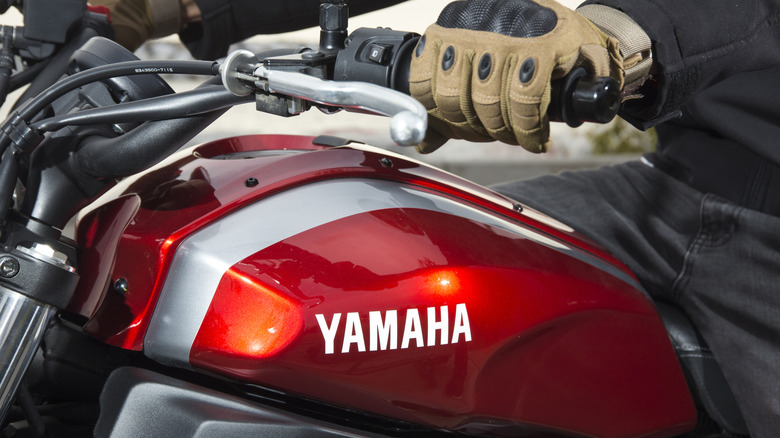 The fuel tank on a red Yamaha motorcycle.
