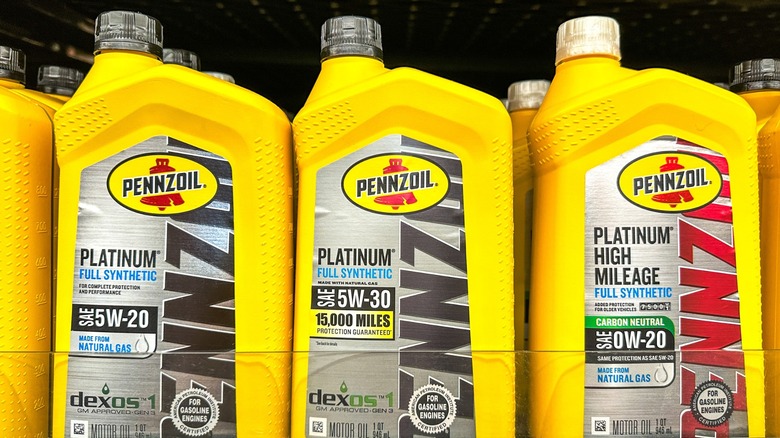 A selection of engine oils on a retail store shelf.