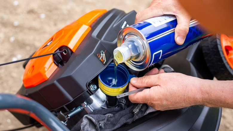 Topping up lawn mower with oil