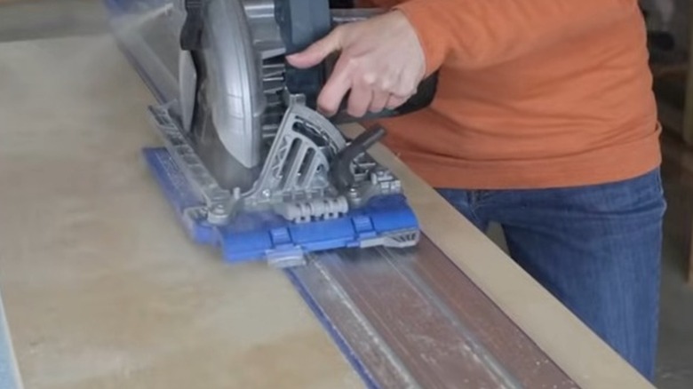 A person using the Accu-Cut saw track