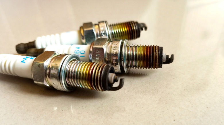 A close-up image showing three badly burnt spark plugs.