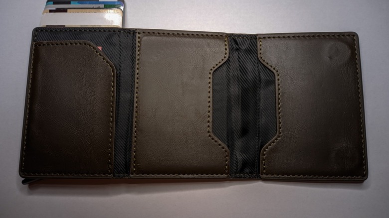 RFID-blocking wallet stretched open with a pile of cards spilling out of a pocket