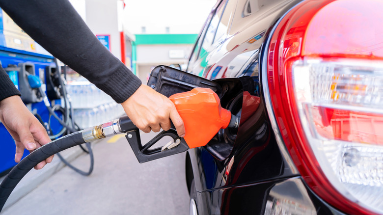 Pumping fuel at gas station