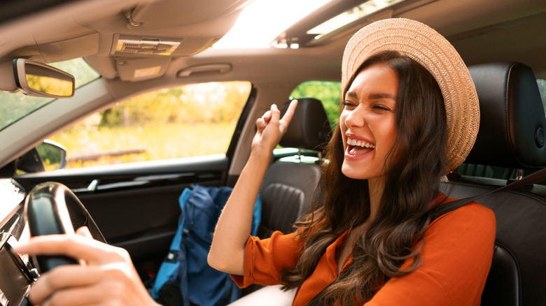 A person singing while behind the wheel of a vehicle