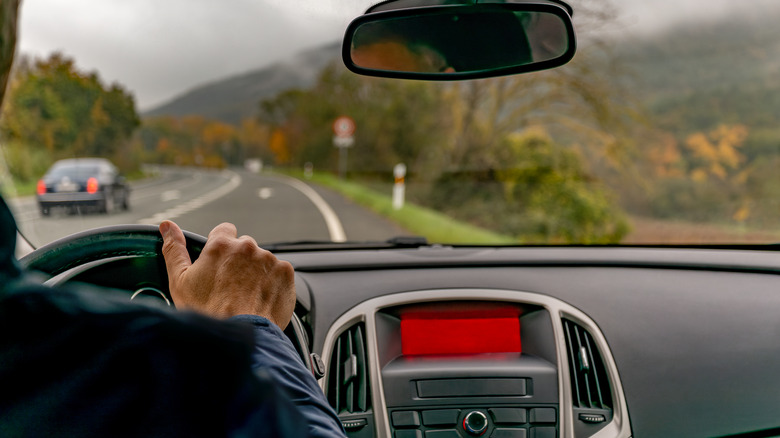 A person driving down a rural road.