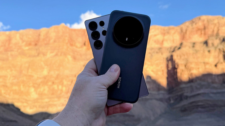 man holding two phones