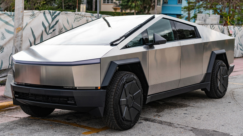 A Tesla Cybertruck parked on city streets.