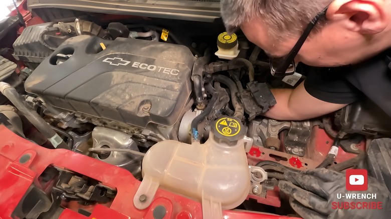 Mechanic replacing a 2015 Chevy Spark's transmission