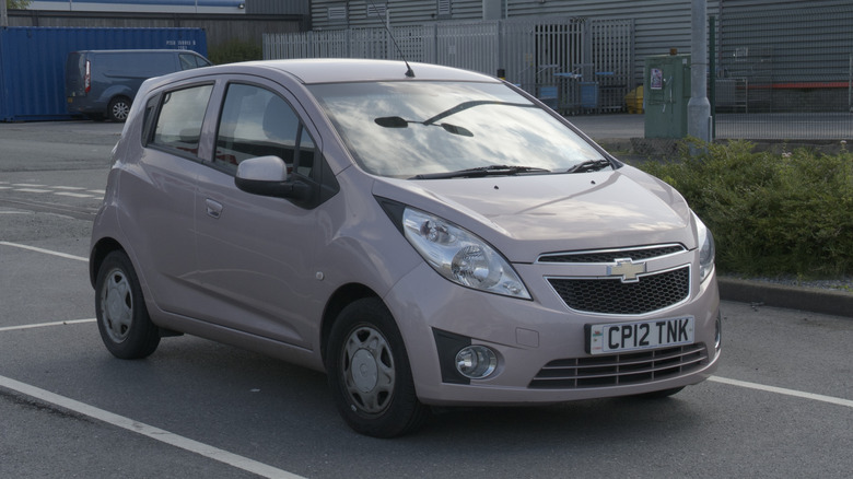 A beige 2015 Chevy Spark in a parking lot