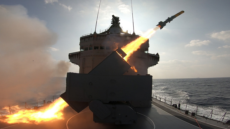 Warship launching missile at sea