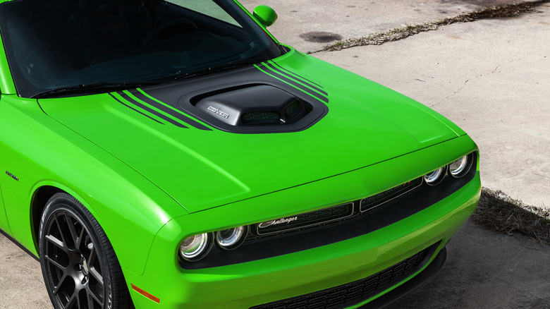 Front end of a green and black 2015 Dodge Challenger R/T Plus Shaker parked on concrete