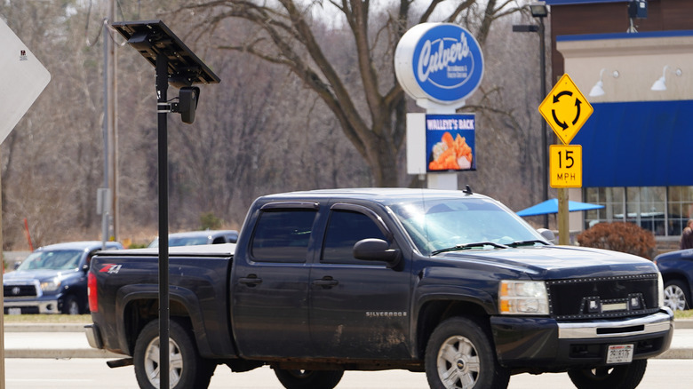 Flock Safety camera monitors vehicles outside a grocery store