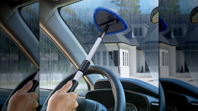 man using windshield cleaner