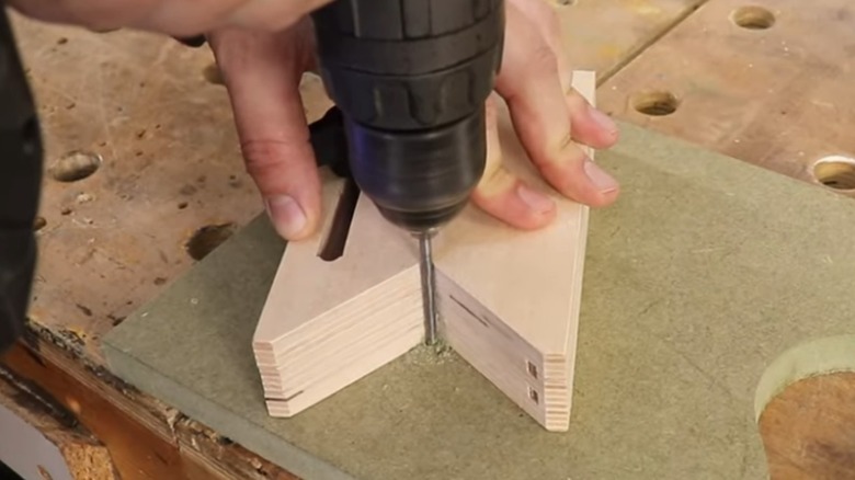 Person drilling using a drill guide jig