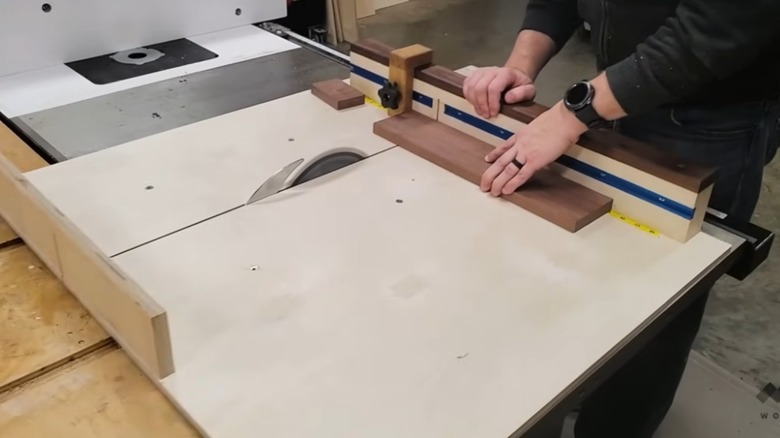Person cutting wood using a cross-cut sled jig