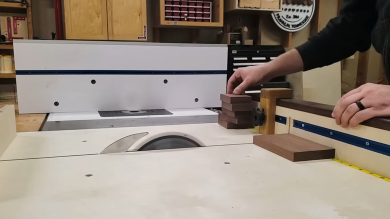 Person cutting wood with a cross-cut sled jig