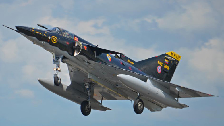 Colombian Air Force KFIR jet in flight from below left