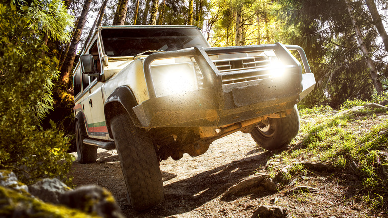 4WD SUV driving on off road trail