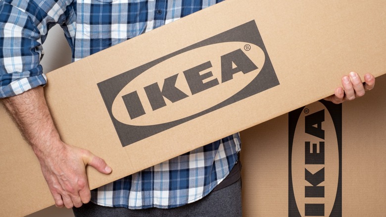 A person carrying boxes of Ikea items