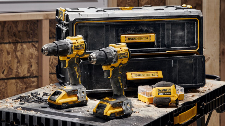 DeWalt's 20V Max ATOMIC Driver and Hammer Drill placed near a DeWalt toolbox