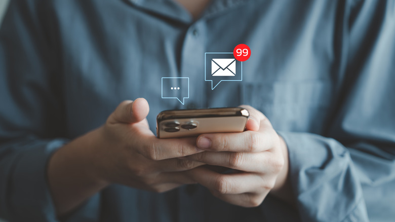 An illustration of notifications coming out of an iPhone held by a person