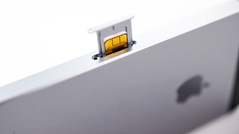 A physical SIM popping out of an iPhone