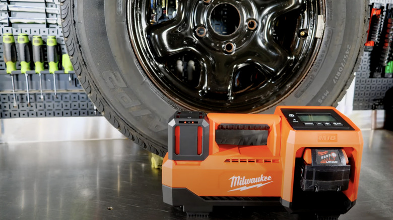 M18 tire inflator in front of car